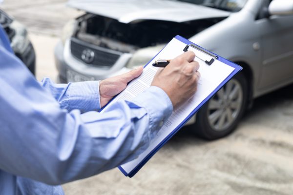 Insurance officer agent working during on site car accident claim process